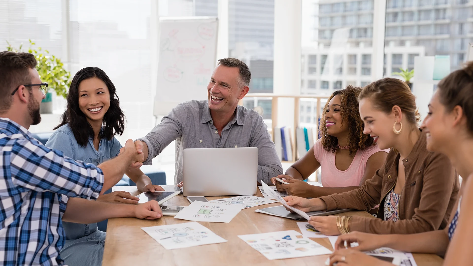 executives-shaking-hands-in-the-meeting