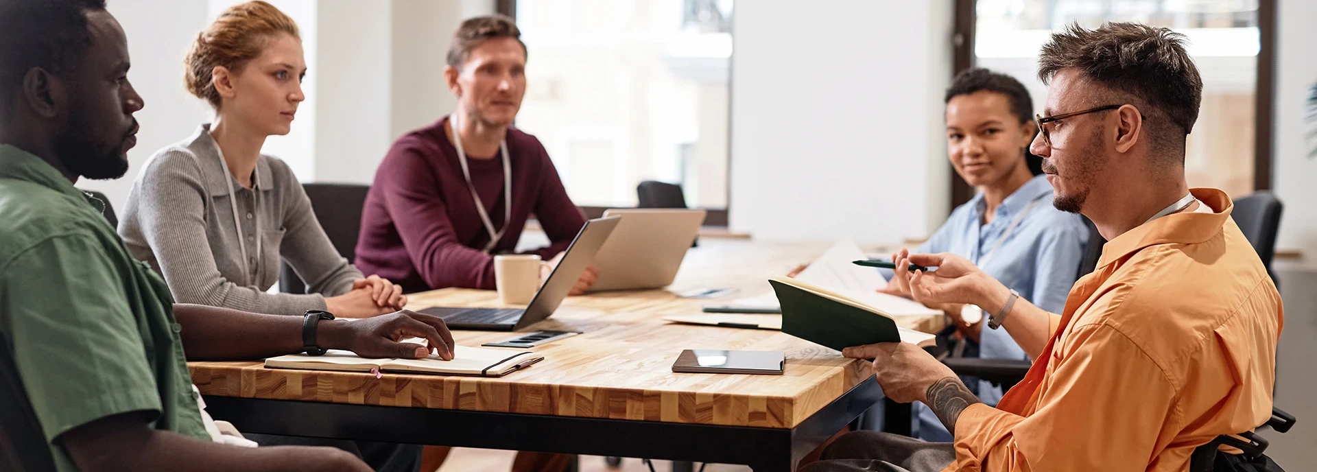 man-with-disability-having-meeting-with-colleagues