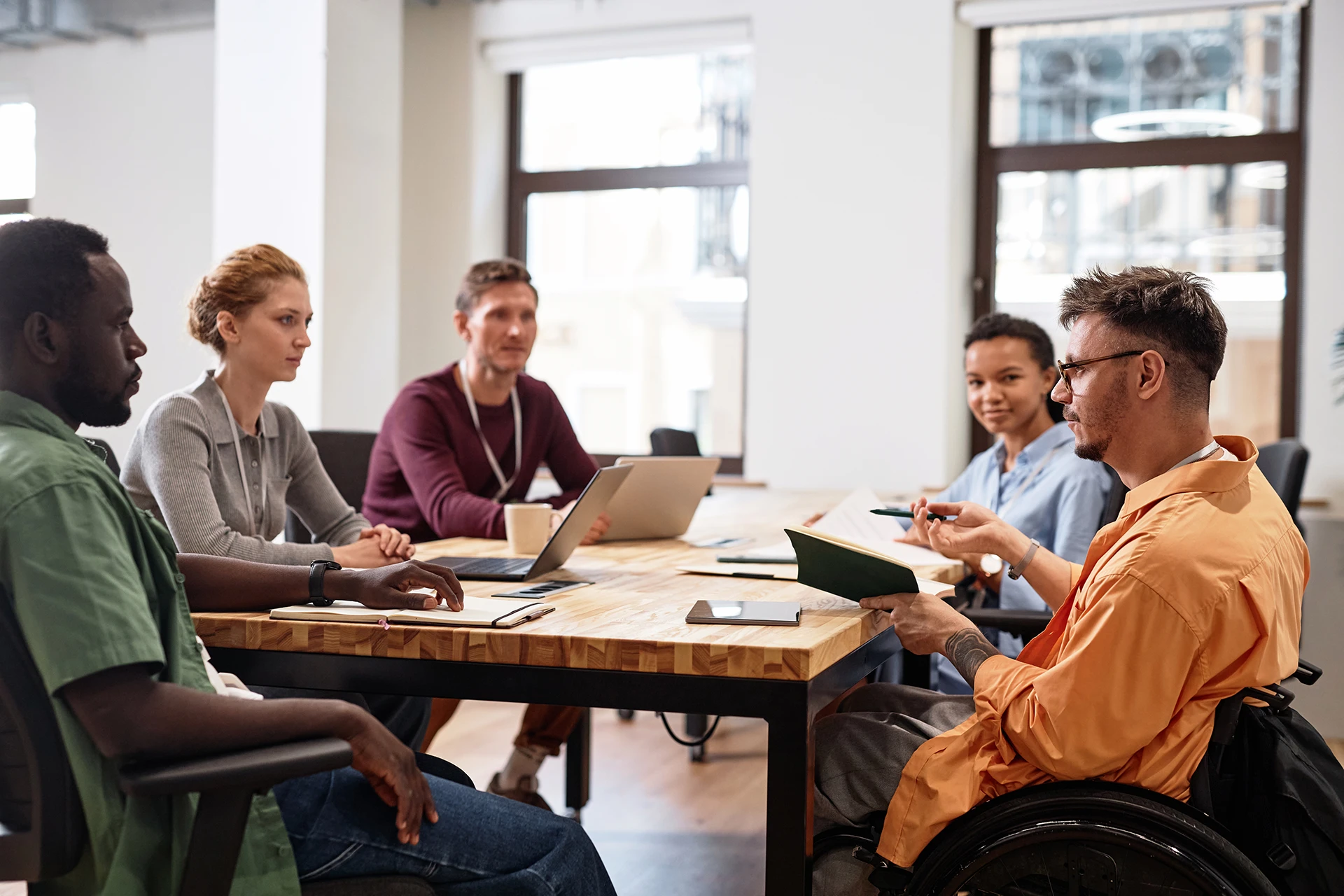 man-with-disability-having-meeting-with-colleagues